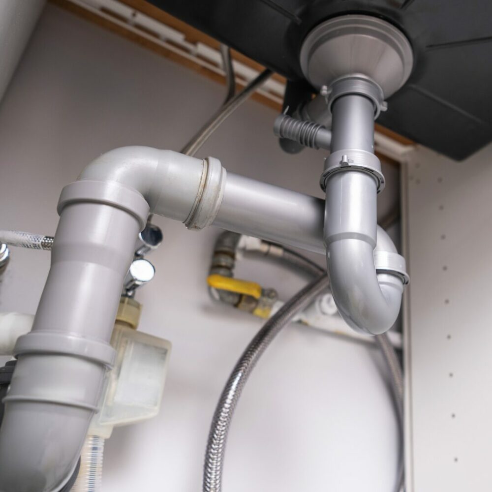 Plumber repairing a burst geyser