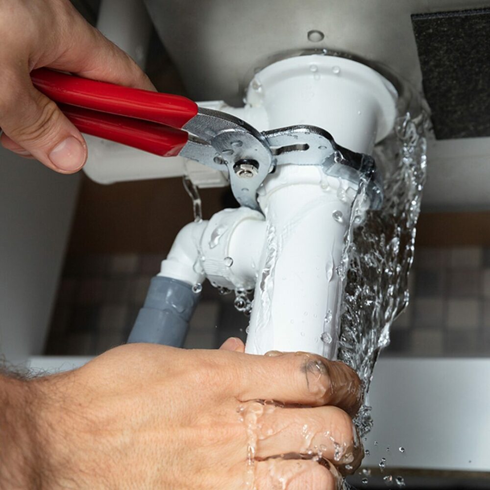 Plumber repairing a burst geyser
